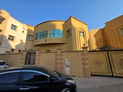 For annual rent in Al Rawda 1: a villa featuring five master bedrooms, a majlis, a living area, and 
