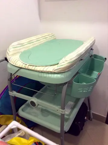 Mint green baby changing table with storage and bath tub