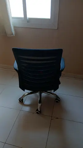 Black mesh ergonomic office chair on wheels