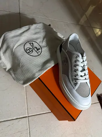 White low-top sneakers with orange box and dust bag — gently used