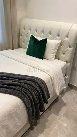 White tufted faux leather single bed with headboard and mattress