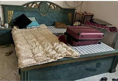 King size ornate wooden bed frame with mattress (used) a dresser and a six doors cupboard.