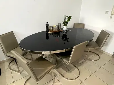 Urgent sale of Modern oval glass dining table with 6 leather chairs - stainless steel base