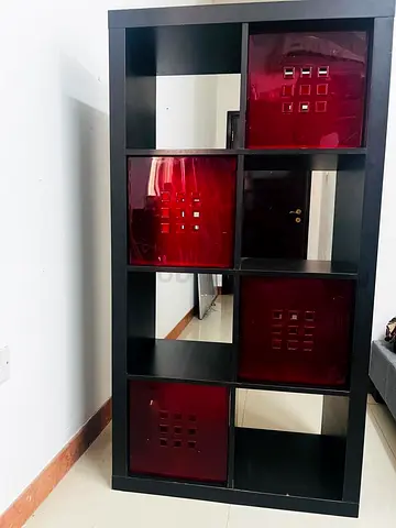 IKEA Kallax-style 8-cube shelving unit with red cube drawers