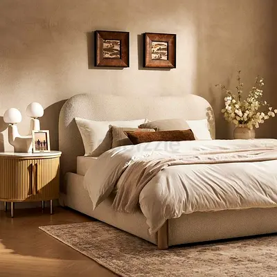 Queen-sized upholstered bed with curved headboard in cream boucle