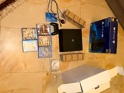 Sony PS4 Pro with orignal controller, original box and 5 games - good condition