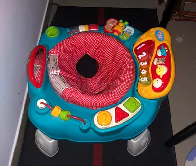 Baby activity jumper/exersaucer with toys and music -very good condition