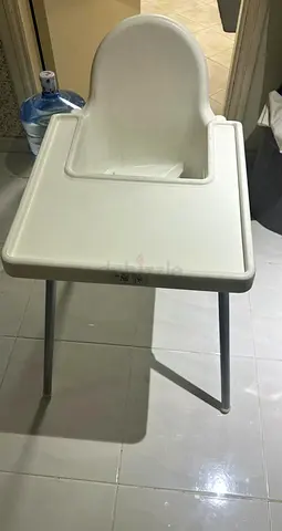 Simple white baby high chair — sturdy plastic seat with tray