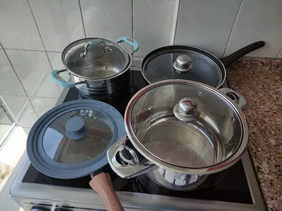 Set of stainless steel pots and pans with glass lids - good condition