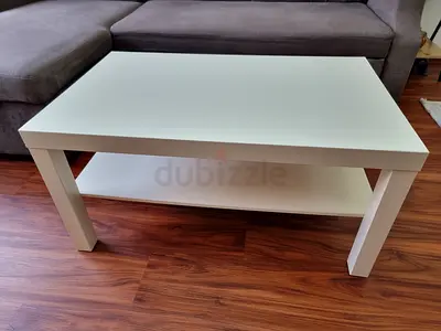Simple white rectangular coffee table with lower shelf
