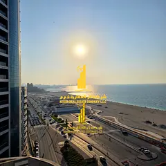 Luxurious three-bedroom apartment with a living room and direct sea view in Ajman - Corniche - furni