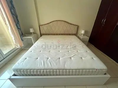 Queen bed frame with mattress and two bedside tables - good condition