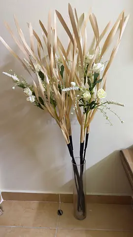 Tall decorative artificial pampas and white rose arrangement in glass vase