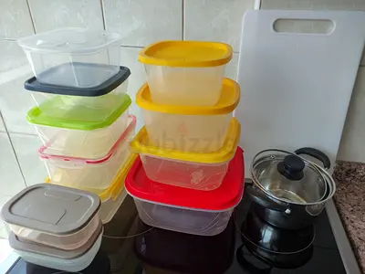 Assorted plastic food storage containers + small pot and cutting board - used