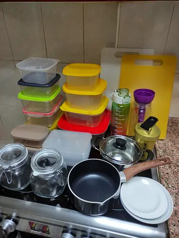 Assorted plastic food storage containers + small pot and cutting board - used