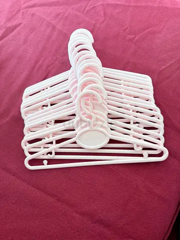 Set of white plastic clothes hangers (0+) - good condition for baby