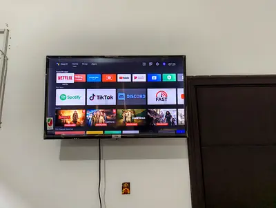32-inch Smart LED TV mounted with Android apps (Netflix, YouTube, Spotify)