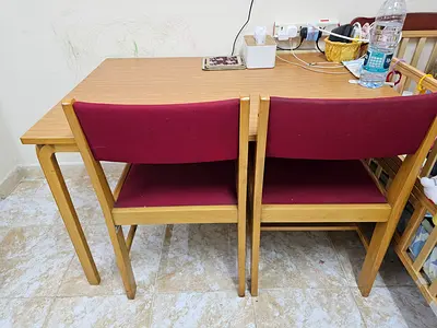 Wooden dining table with four upholstered chairs - compact set