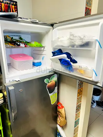 Used Top-Freezer Refrigerator - Compact Silver Refrigerator with Freezer for Urgent Sale.