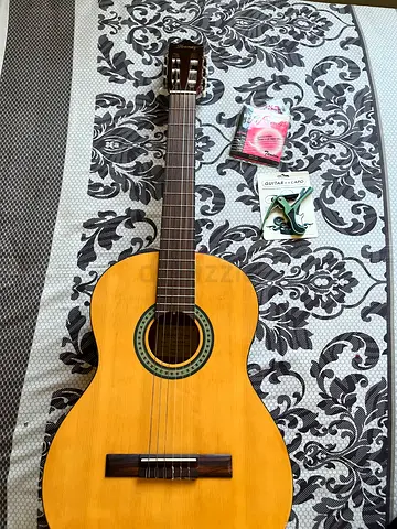 Second-hand classical acoustic guitar. Includes extra strings, capo, and cover.