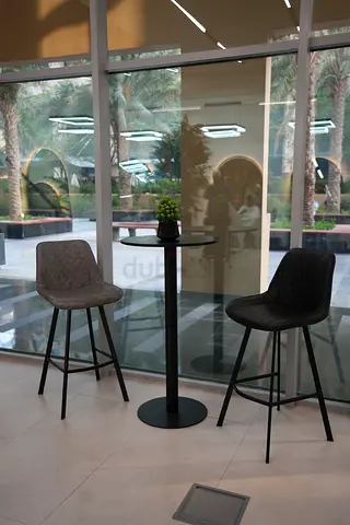 Compact round bar table with two modern bar stools