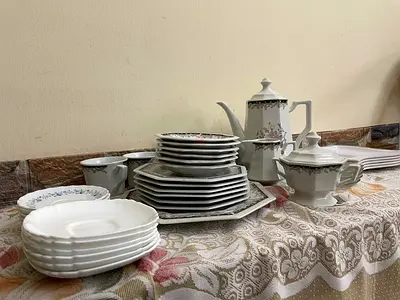 White porcelain dinnerware set with cups and serving pieces at reasonable price