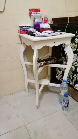 Small white wooden side table with lower shelf
