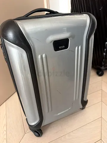 TUMI Silver hard-shell carry-on suitcase with minor scratches