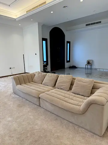 Light beige 4-seater curved fabric sofa in good condition