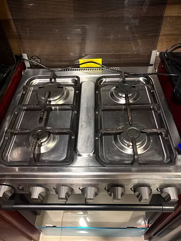 Used stainless steel 4-burner gas stove with oven