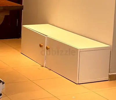 Low white wooden storage cabinet / TV stand with two doors
