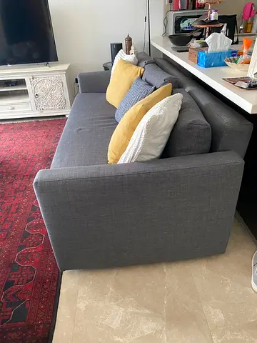 Gray 3-seater sofa bed in excellent condition with 2 cushions