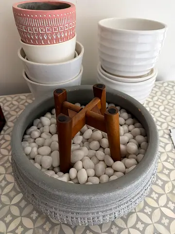Set of decorative plant pots with pebble-filled planter and wooden stand