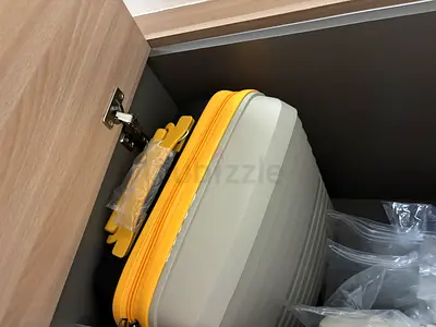 Lightweight hard-shell carry-on suitcase with yellow trim