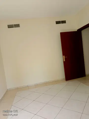For annual rent: a one-bedroom and living room apartment in Al Qasimia (Al Nad)—spacious layout, lowest price in Sharjah.