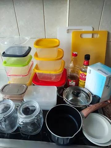 Assorted plastic food storage containers + small pot and cutting board - used