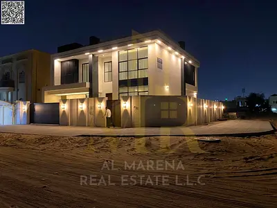 Corner villa, two floors and a roof, in one of the most prestigious areas of Ajman, on a main street, with the price including electricity, water and