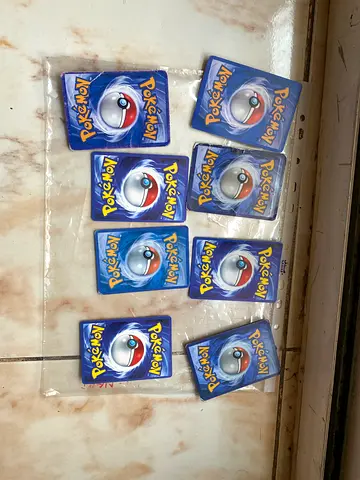 Lot of 8 Pokemon trading cards (backs shown) — used collection