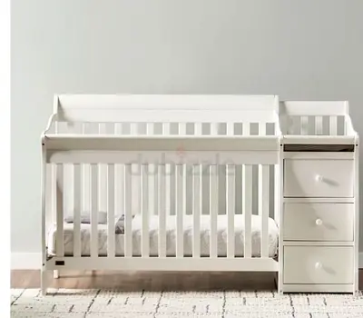 White convertible baby crib with attached changing table and drawers