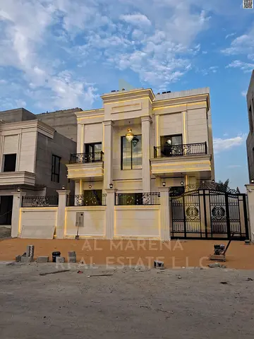 Modern villa for sale in Al Helio, Ajman. Two floors and a roof terrace. 6 master bedrooms. Includes registration and ownership fees. Freehold.
