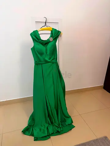 Emerald green floor-length evening dress with brooch detail