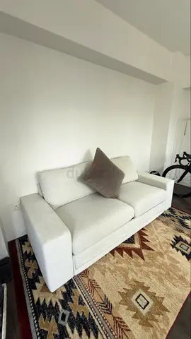 Light beige 2-seater fabric sofa bed in good condition