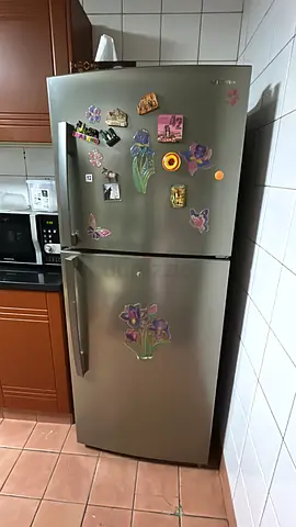 Used stainless steel double-door refrigerator in working condition but with water leakage into fridg