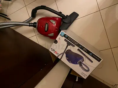 Used canister vacuum cleaner - compact red model, working condition
