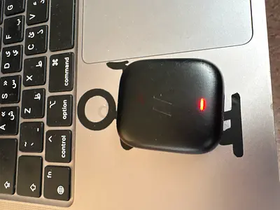 Used wireless earbuds with charging case (red charging indicator) - good condition