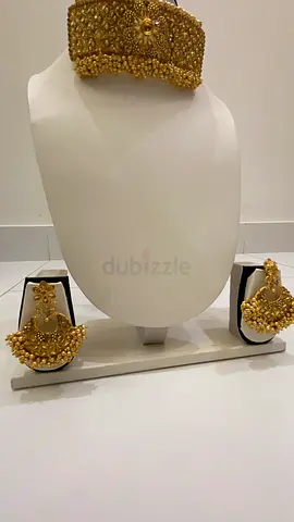 Gold-tone traditional bridal necklace set with matching earrings and maang tikka