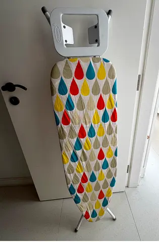 Ironing board with wall stand to hand the iron
