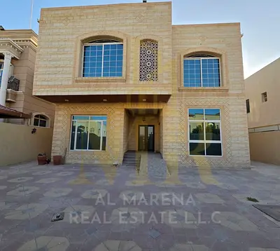 Villa for sale in Ajman, Al Rawda area. 5 master bedrooms, majlis, living room, and maid's room. Freehold ownership available to all nationalities. Ba