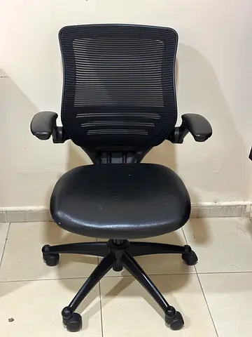 Black ergonomic mesh office chair with armrests and wheels