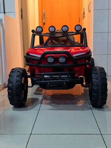 Red electric ride-on buggy for kids — good condition